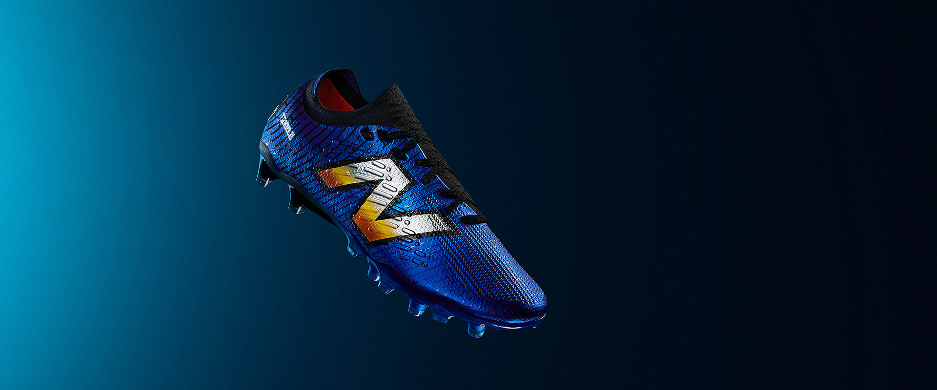 New Balance Tekela V4+ Low Laced Pro Firm Ground - Blue/Orange