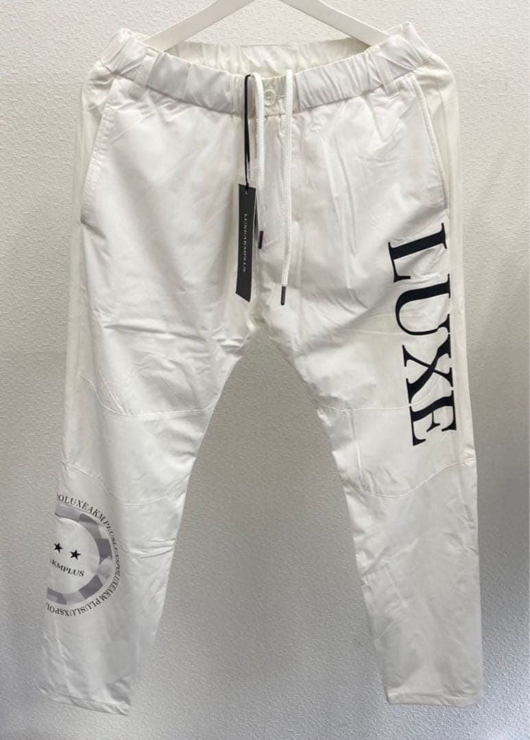 リュクスエイケイエムプラス ゴルフ 防風 サークルロゴウィンドウパンツ＆ウェア