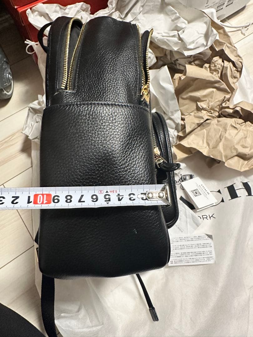 バッグ COACH PEBBLED LEATHER COURT BACKPACK
