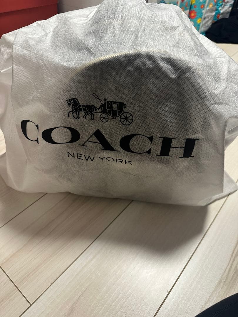 バッグ COACH PEBBLED LEATHER COURT BACKPACK